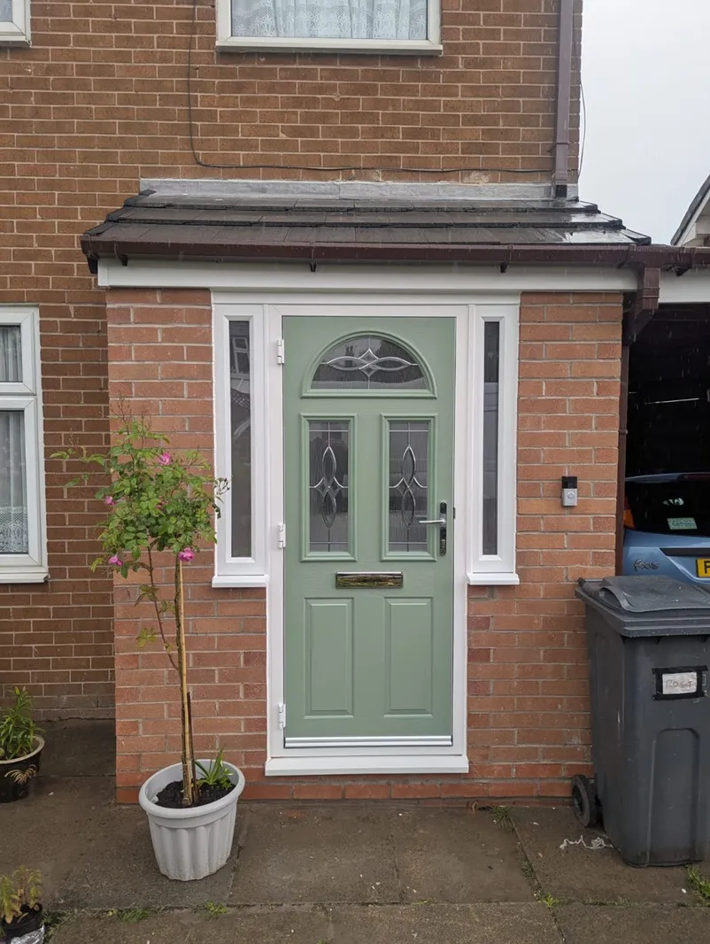 Sage green composite front door with decorative glazing and white PVC frame
