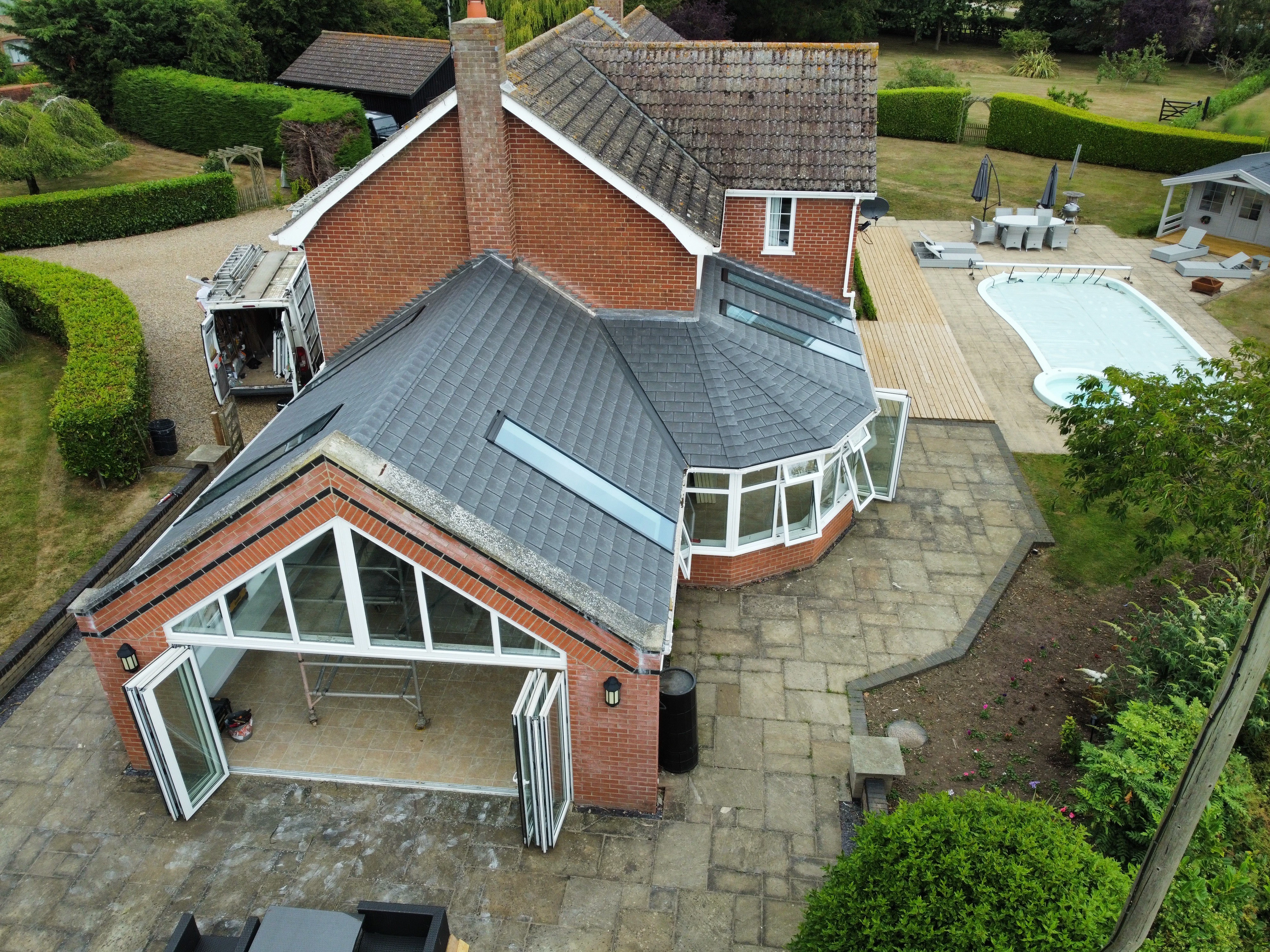 Aerial view of a tiled-roof conservatory and gable extension on a detached house
